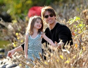 Tom Cruise is all smiles in helicopter ride while Katie Holmes drops daughter Suri off at college